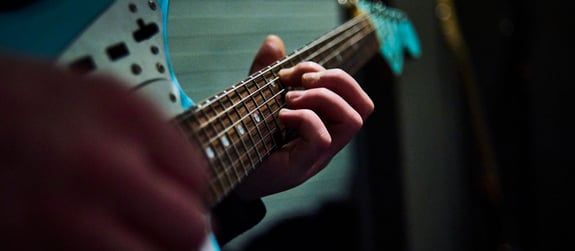 A closeup of someone playing an electric guitar