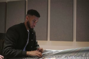 dBs Institute student producing music on an SSL mixing desk