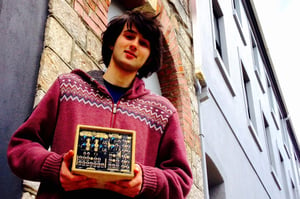 Fenn Marks holding one of his eurorack modules outside of dBs Plymouth