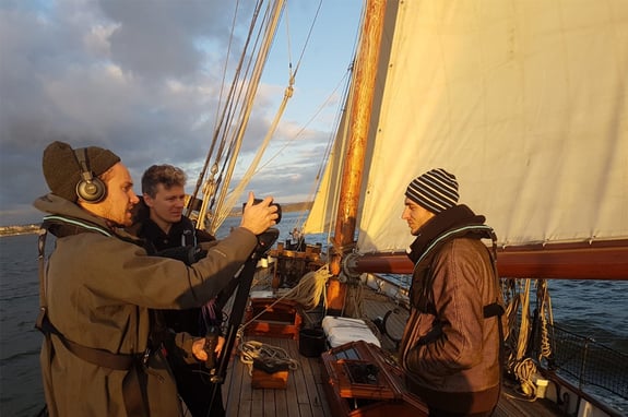 Two dBs students and dBs Pro creative director recording sound aboard an 18th century sailboat in Plymouth